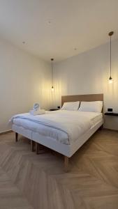 a bedroom with a large bed with white sheets at RASHI6 Boutique Villa in Netanya