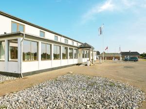 a building with a lot of windows in a parking lot at Apartment in Holiday park- shared kitchen in Ulfborg