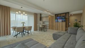 a living room with a couch and a table at Le Luna Apart in Braşov