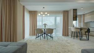 a dining room and kitchen with a table and chairs at Le Luna Apart in Braşov +6 photos