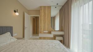 a bedroom with a bed and a mirror at Le Luna Apart in Braşov
