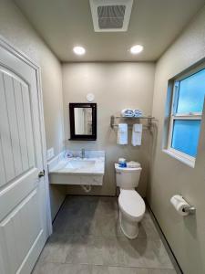 a bathroom with a toilet and a sink at Travelers Inn Eugene University in Eugene