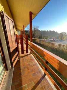 a porch of a house with a view of a field at Rucola Home in Castione della Presolana