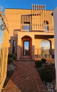 a brick house with a balcony on top of it at ZenHome in Craiova