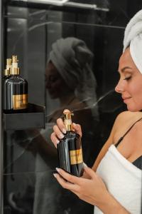 帕雷斯阿吉萨那VORAS 180° VIEW的一位女士手里拿着一瓶香水