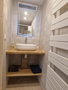 a bathroom with a sink and a mirror at Le petit céretant in Céret +5 photos