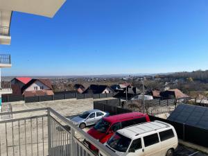 two cars are parked in a parking lot at Apartament in Ipotești in Ipoteşti