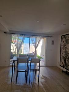 a dining room with a table and chairs and a window at Le petit céretant in Céret