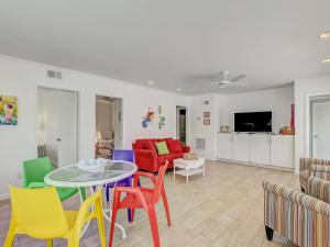 a living room with a table and colorful chairs at Coops Retreat Unit B in Tybee Island