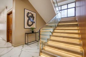 a staircase in a house with wood and glass treads at Hotel Sukoon & Banquet Hall Near Bhopal Railway Station in Bhopal