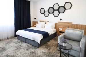 a bedroom with a bed and a couch at Hotel Karting in Mostar