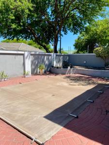 a large concrete parking lot with a tree in the background at Ubuntu Guest House in Cape Town +15 photos
