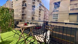 a balcony with a table and chairs on a balcony at APARTAMENTO SOL Y PLAYA in Santa Pola