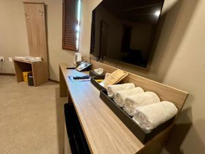 a bathroom with towels on a counter with a television at 계룡 호텔 스테이318 in Gyeryong