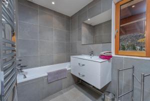 a bathroom with a sink and a bath tub at Les Sept Étoiles in Le Monêtier-les-Bains +31 photos