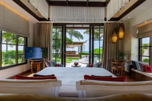 a bedroom with two beds and a living room at OZEN RESERVE BOLIFUSHI - Luxury All Inclusive with Free Transfers in Male City