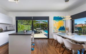 a kitchen and dining room with a table and chairs at Villa Angello in Matulji