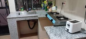 a kitchen with a sink and a toaster on a counter at Friendly House in Arusha