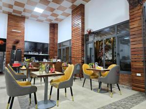 a restaurant with tables and chairs and a bar at Fla Village in Phú Quốc