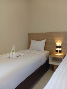 Ένα ή περισσότερα κρεβάτια σε δωμάτιο στο INARA By Kiyana +1 φωτογραφίες