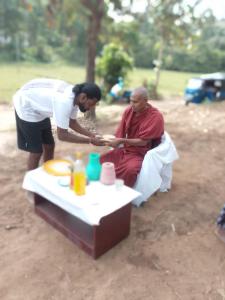 a man is helping a man sitting on the ground at Lahima Cabanas in Dickwella +16 photos