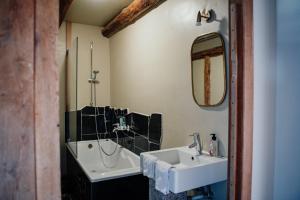 a bathroom with a sink and a mirror at Buteo chambres d'hôtes & espresso in Lesterny +48 photos