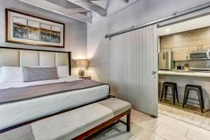 a bedroom with a large bed and a kitchen at Parker's Collection Unit 5 in Savannah