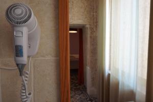 a hair dryer hanging on a wall next to a room at Il-Wileg B&B in Qala