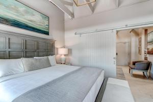 a bedroom with a large bed with a large painting on the wall at Parker's Collection Unit 6 in Savannah +18 photos