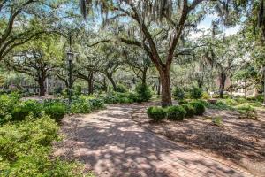 a walkway in a park with trees and bushes at Parker's Collection Unit 6 in Savannah