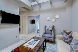 a living room with a couch and a tv at Parker's Collection Unit 7 in Savannah