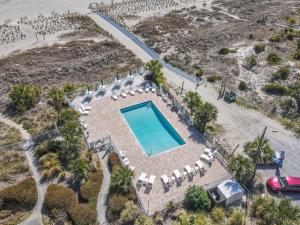 an aerial view of a swimming pool with lounge chairs and a swimming pool at Ocean Pearl in Tybee Island