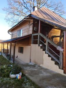 a house with a staircase on the side of it at Casa Dominic in Gîrda de Sus