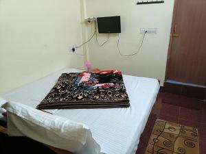 a blanket sitting on a bed in a room at ooty hill stay in Ooty