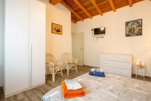 a room with a bed and a tv on the wall at Villa Nicola in Camaiore