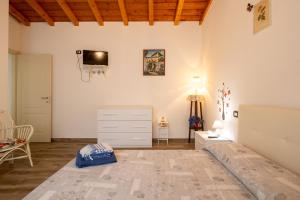 a room with a dresser and a tv on the wall at Villa Nicola in Camaiore