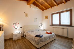 a bedroom with a bed and a window at Villa Nicola in Camaiore