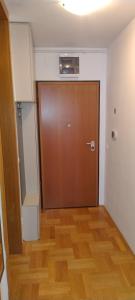 an empty room with a door and a wooden floor at Lux Apartmans in Zagreb