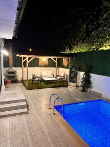 a backyard with a swimming pool at night at Quiet House in İznik