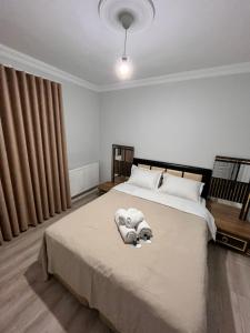 a bedroom with a bed with towels on it at Quiet House in İznik