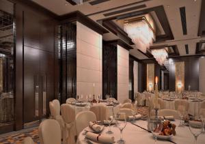 a banquet hall with white tables and chairs and chandeliers at Grand Canyon Hotel in Ankara