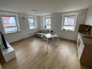 a living room with a couch and a table at kreuzwirt bayern in Essenbach