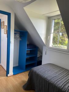 a bedroom with a blue bed and a window at KER-ROHEN SUROIT in Bangor +5 photos