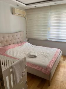 a bedroom with a bed in a room with a window at Detached 800 square meter villa with forest view in the city in Pamukkale +17 photos