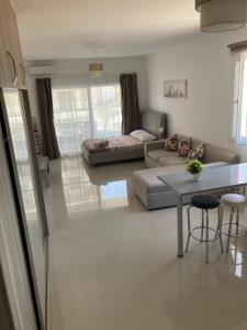 a living room with a couch and a table at Квартира Апартаменты in Paralimni