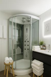 a glass shower in a bathroom with a sink at La Suite Secreta del Júcar in Alcalá del Júcar