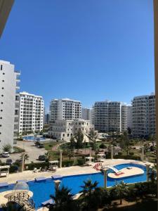 a view of a city with two pools and buildings at Квартира Апартаменты in Paralimni