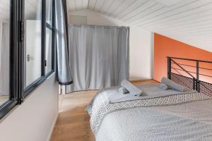 a bedroom with a bed and a large window at La Rousseline - Bord de Sèvre, Calme & Moderne in Boussay