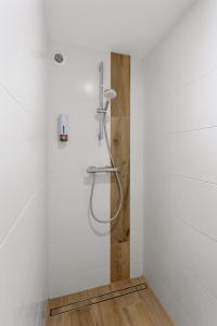 a shower in a bathroom with white walls at La Rousseline - Bord de Sèvre, Calme & Moderne in Boussay +23 photos