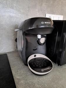 a black coffee maker sitting on top of a microwave at Apartman MWM Brno 2 in Brno